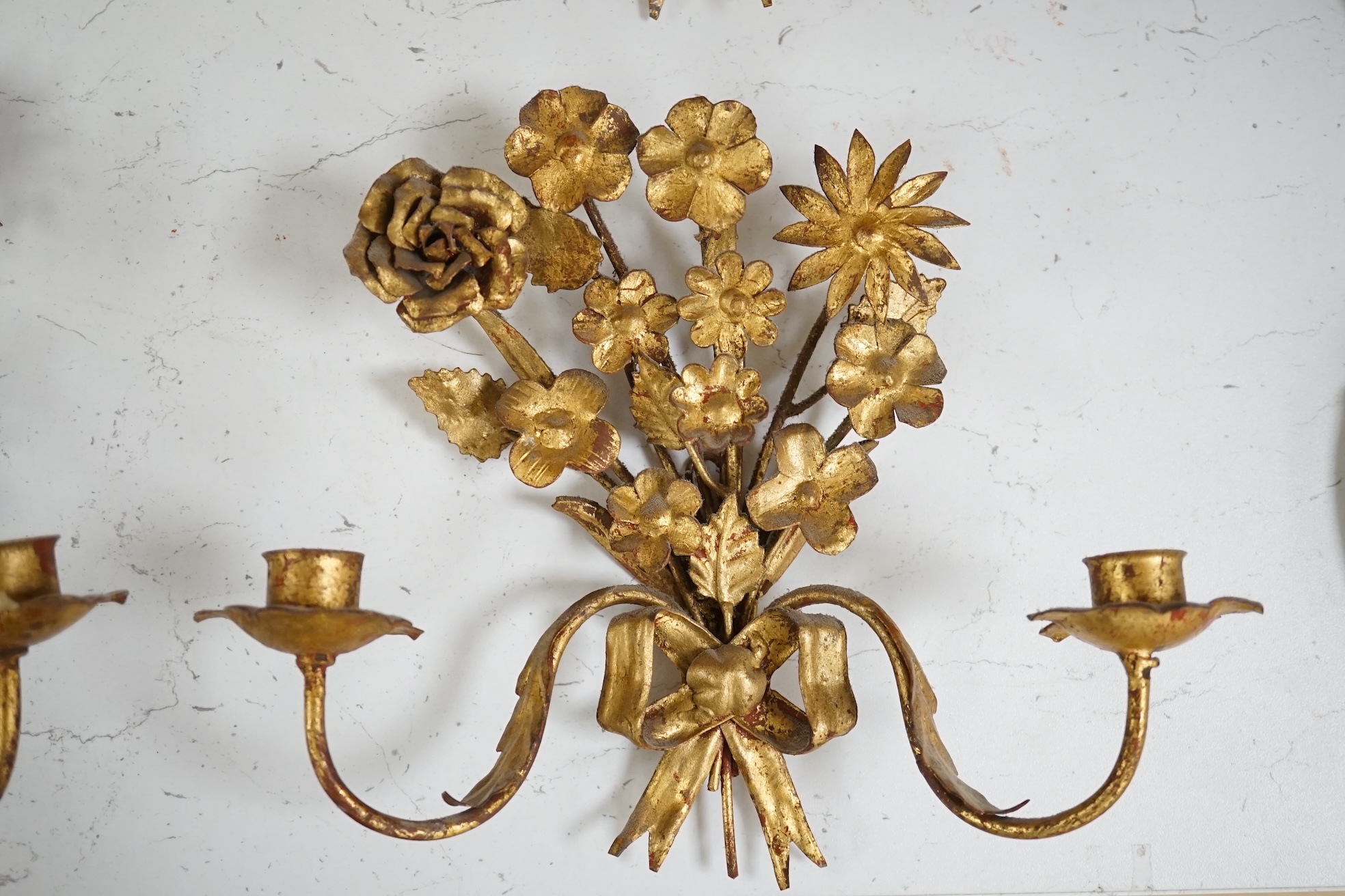 A set of four gilt metal two branch wall sconces, largest 26cm high. Condition - fair